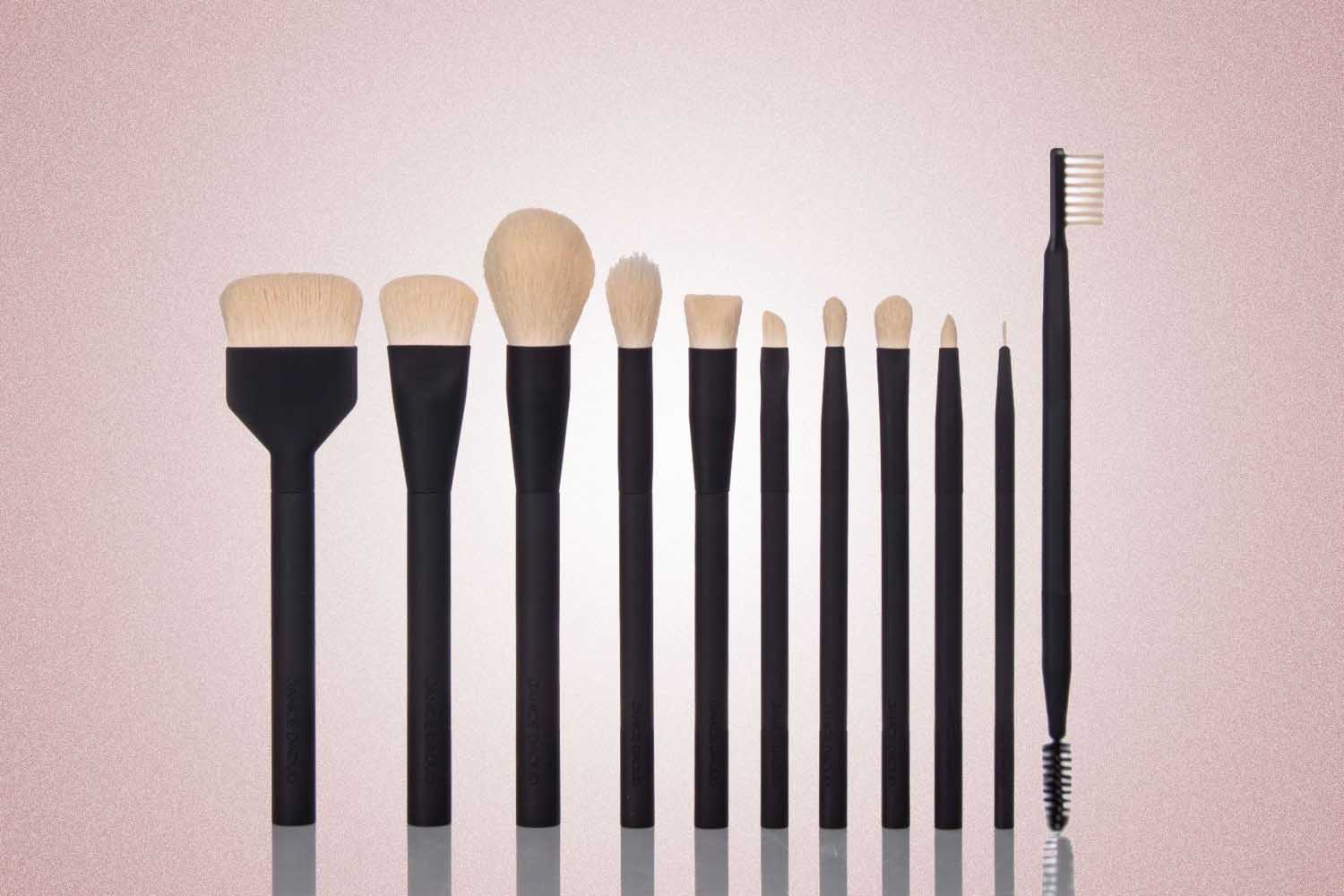 A set of black makeup brushes from Laruce. a perfect Valentine’s Day gift for 2022, on a pink background.