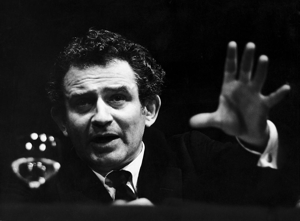 Author Norman Mailer pictured in a black and white photograph at a discussion in the Mayfair Theater in London