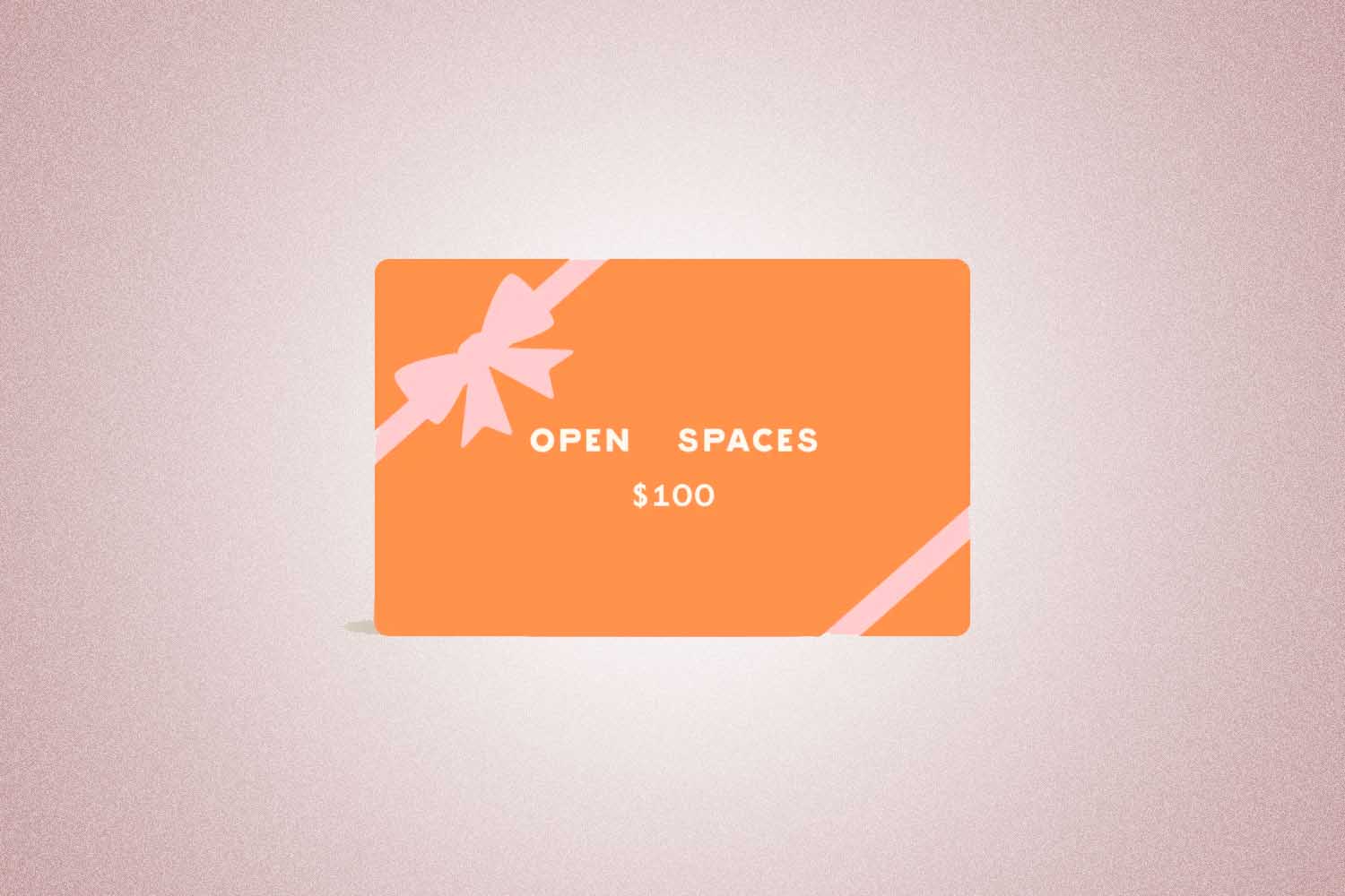 An orange and pink gift card from Open Spaces, a perfect Valentine’s Day gift for 2022, on a pink background.
