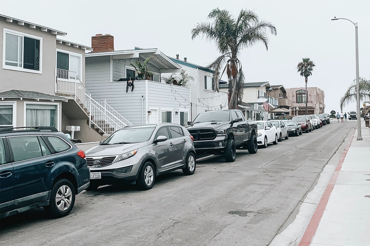 A row of cars, trucks and SUVs parked on a street in California
