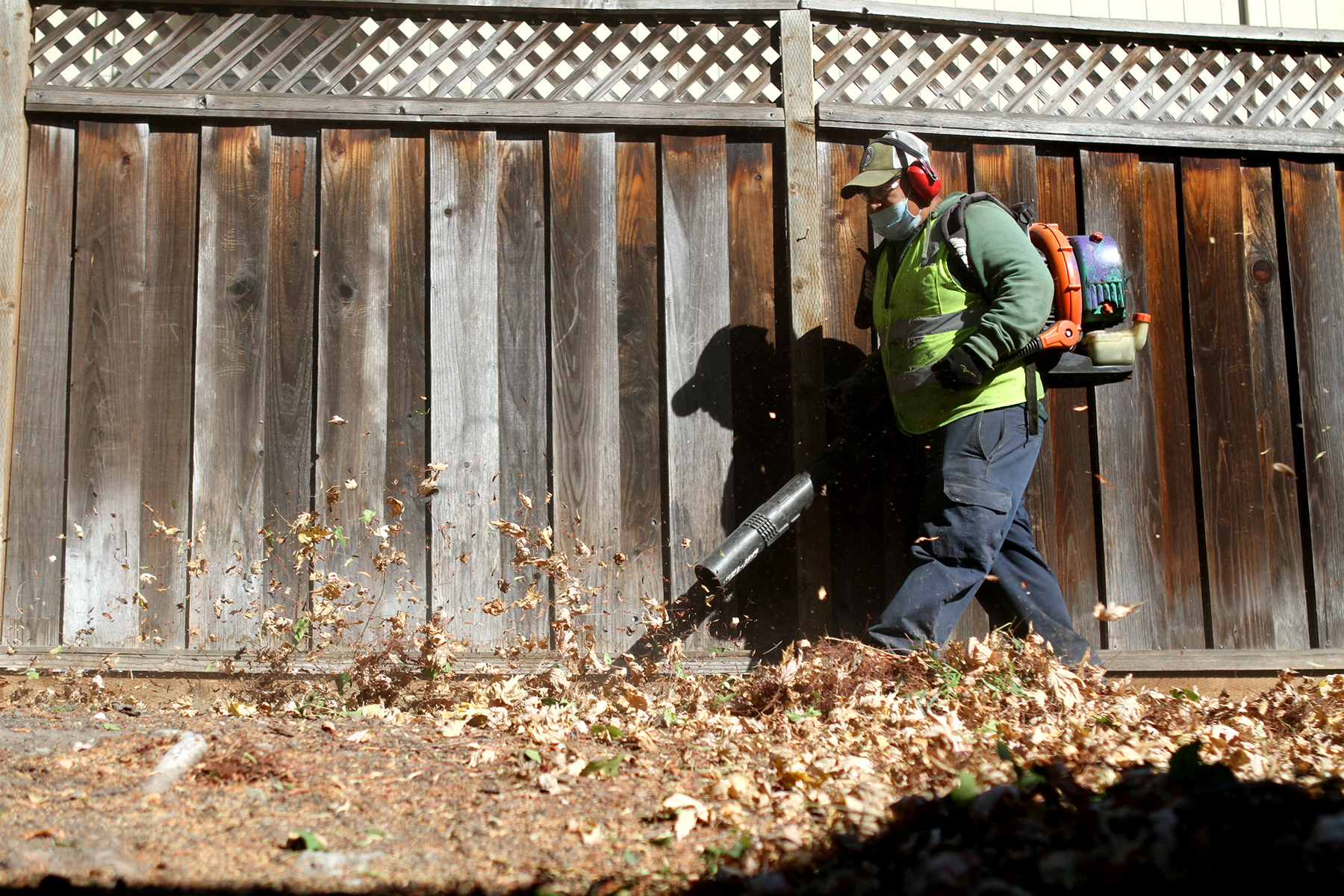 Pedro Ortiz from Allied Landscaping uses a gasoline-powered leaf blower in Dublin, CA, in October