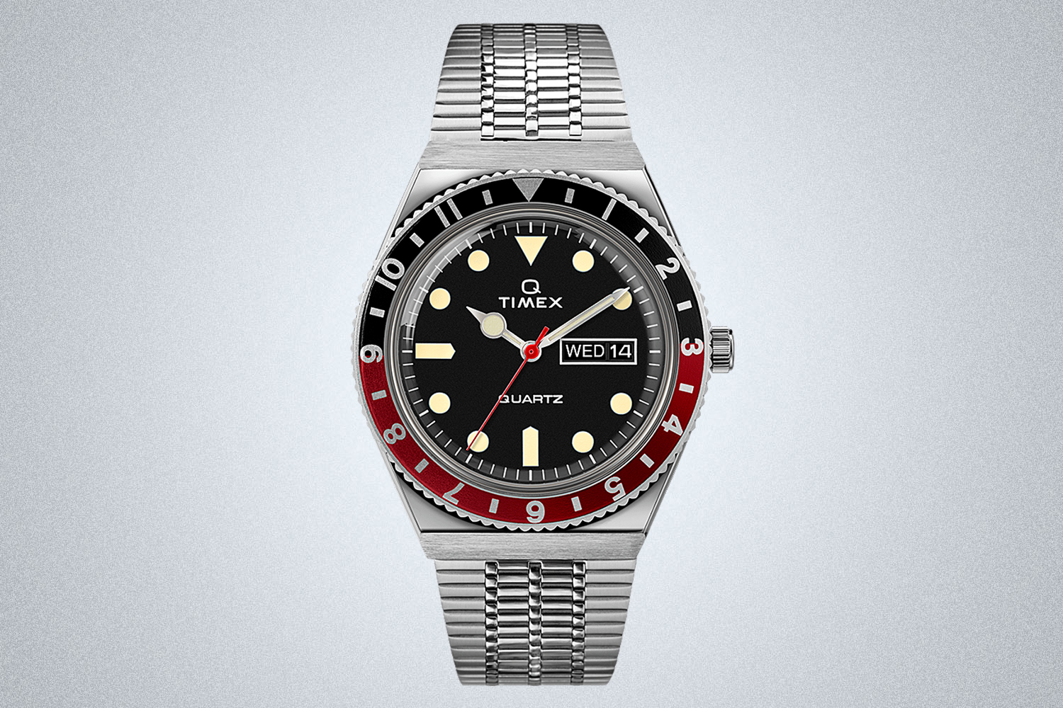 A Q Timex men's watch with a red and black bezel