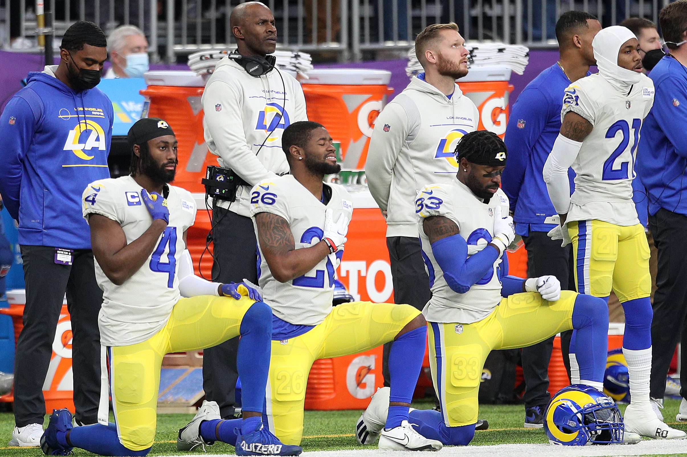 Members of the Los Angeles Rams take a knee during the National Anthem before a 2021 game in Minnesota