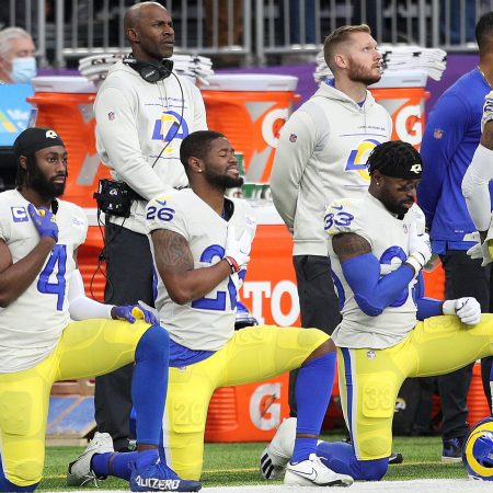 Members of the Los Angeles Rams take a knee during the National Anthem before a 2021 game in Minnesota