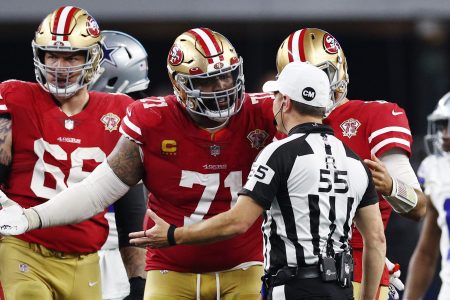 The San Francisco 49ers talk with referee Alex Kemp during the fourth quarter. Despite controversial officiating during the wild card weekend, the NFL says it will not be expanding to include an additional "sky judge" referee.