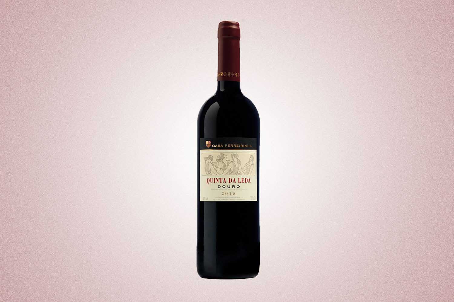 A bottle of red wine from Casa Ferreirinha. The label reads: "Quinta da Leda Douro 2016," a perfect Valentine’s Day gift for 2022, on a pink background.