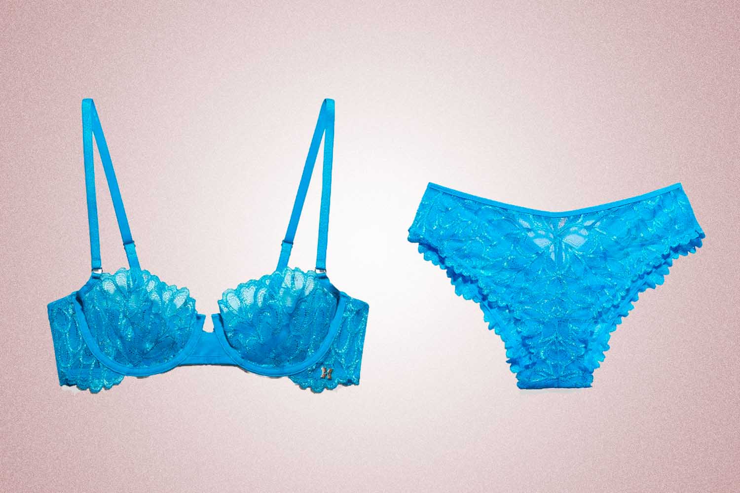 Blue lace bra and underwear set from Savage x Fenty, a perfect Valentine's Day gift, on a pink background. 