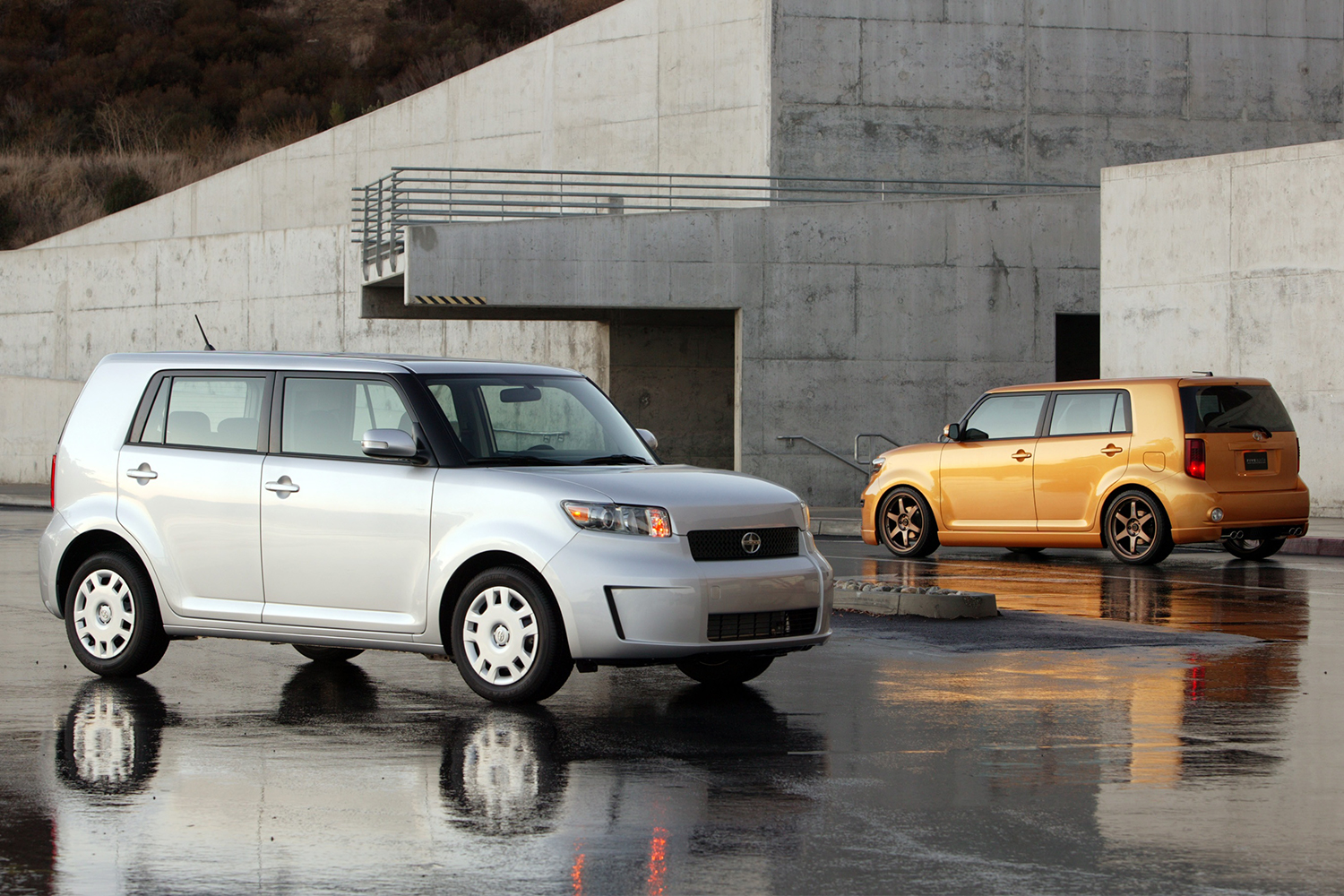 Two 2007 Scion xB hatchbacks in grey and gold