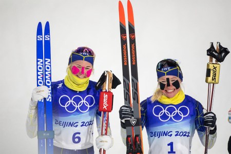Two Olympians competing with KT tape on their faces at the Beijing Olympic Games. Athletes, facing sub-zero wind chill, are getting creative about protecting their faces, using tape.
