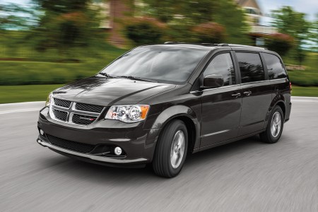 A 2019 Dodge Grand Caravan minivan driving down the road. The price of these used models has increased by 69% between 2021 and 2022.