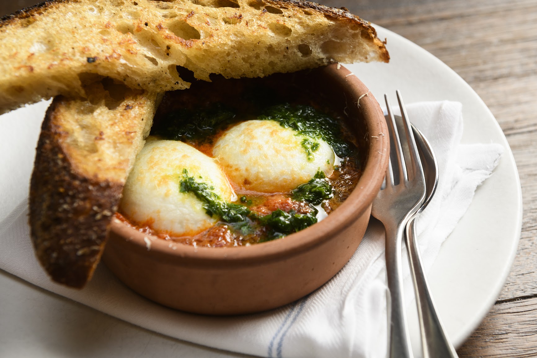 Baked eggs, spicy pomodoro, guanciale, pecorino and garlic bread … oh my!