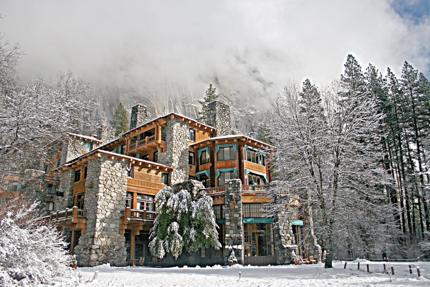 a wooden hotel in a snowy landscape