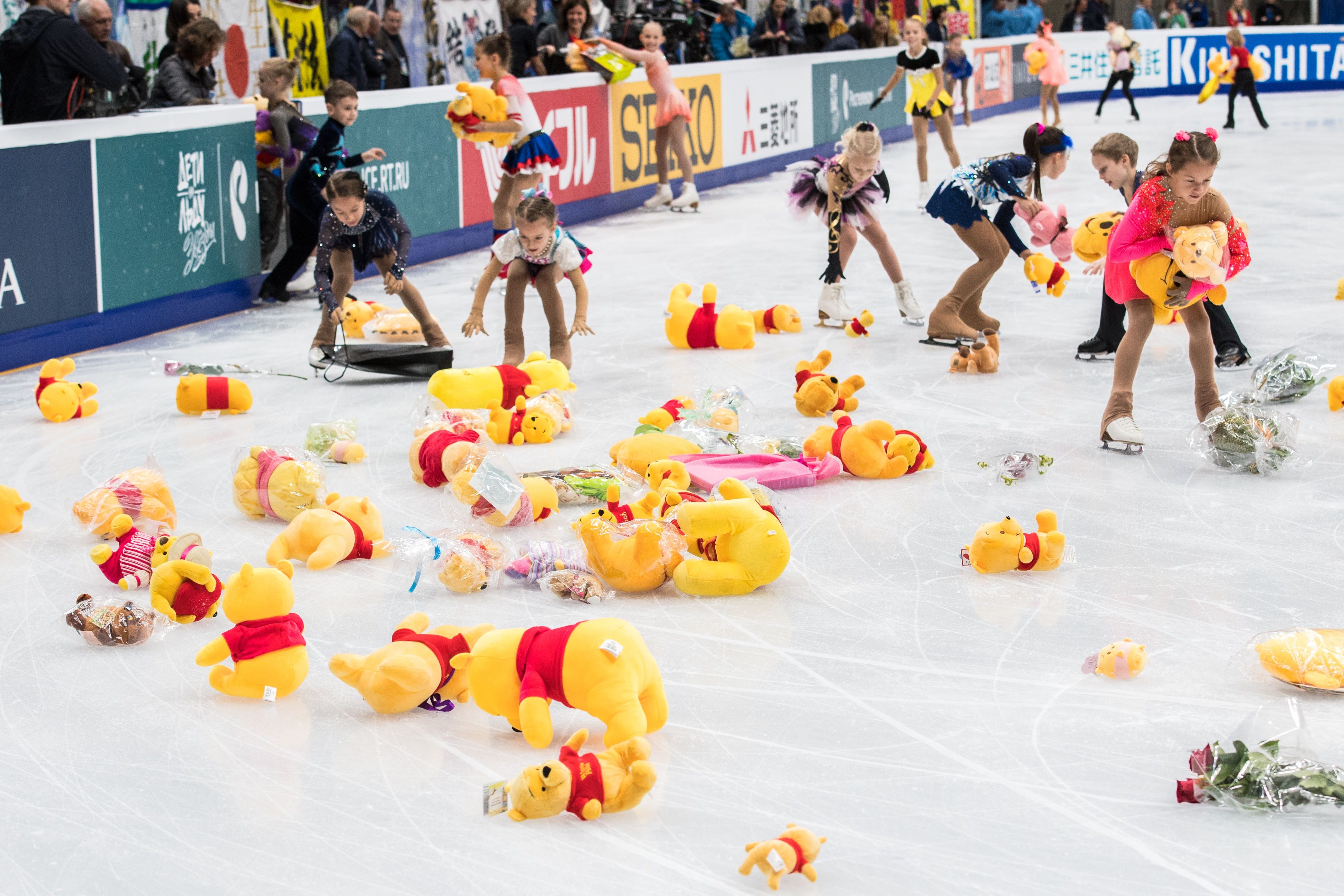 Children collect stuffed toy bears from the ice after Japan's Yuzuru Hanyu performed his routine in the men's short program at the Rostelecom Cup 2017 ISU Grand Prix.