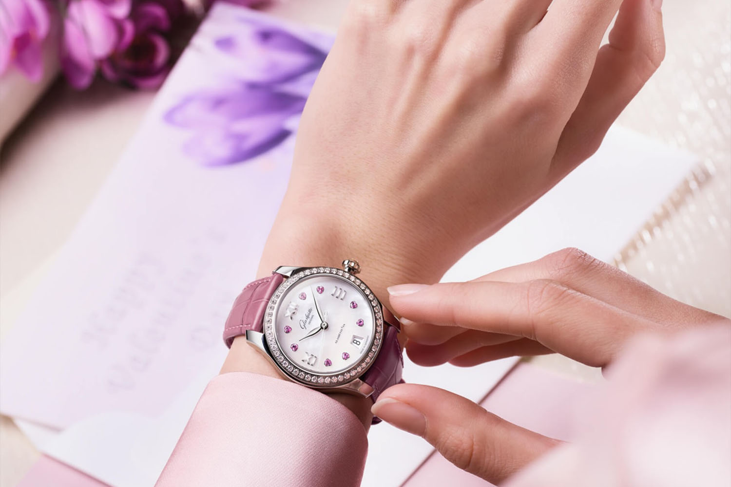 a woman wearing a pink clasped watch