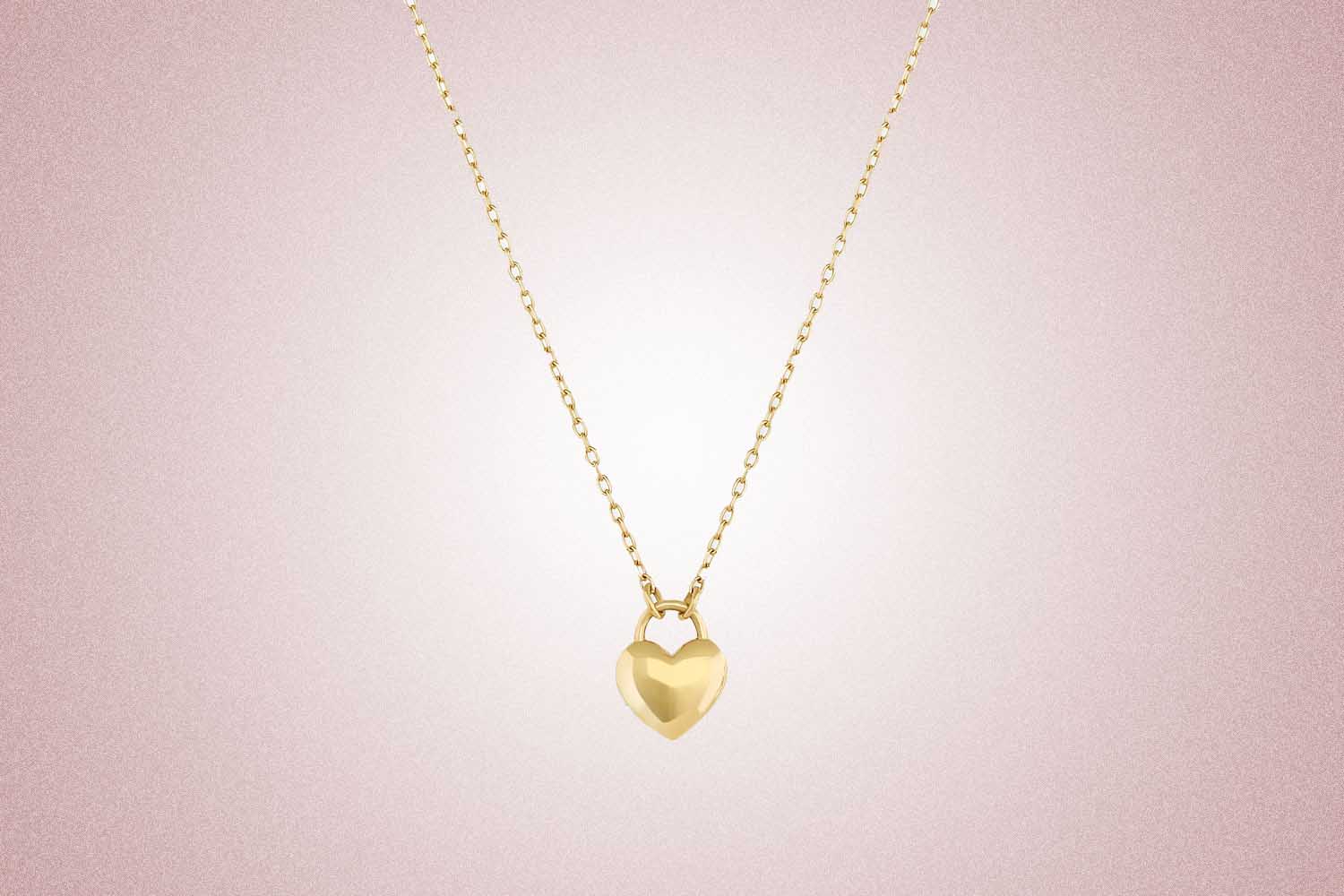 A gold sweetheart padlock charm necklace, a perfect valentine's day gift, on a pink background