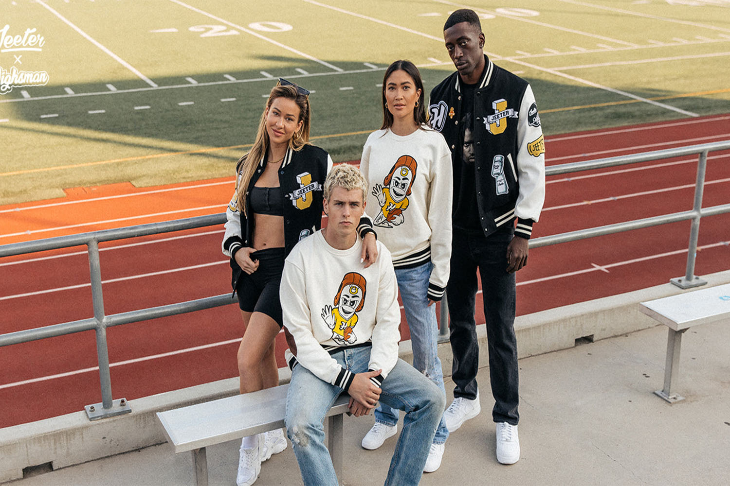 four models sitting in front of a football field