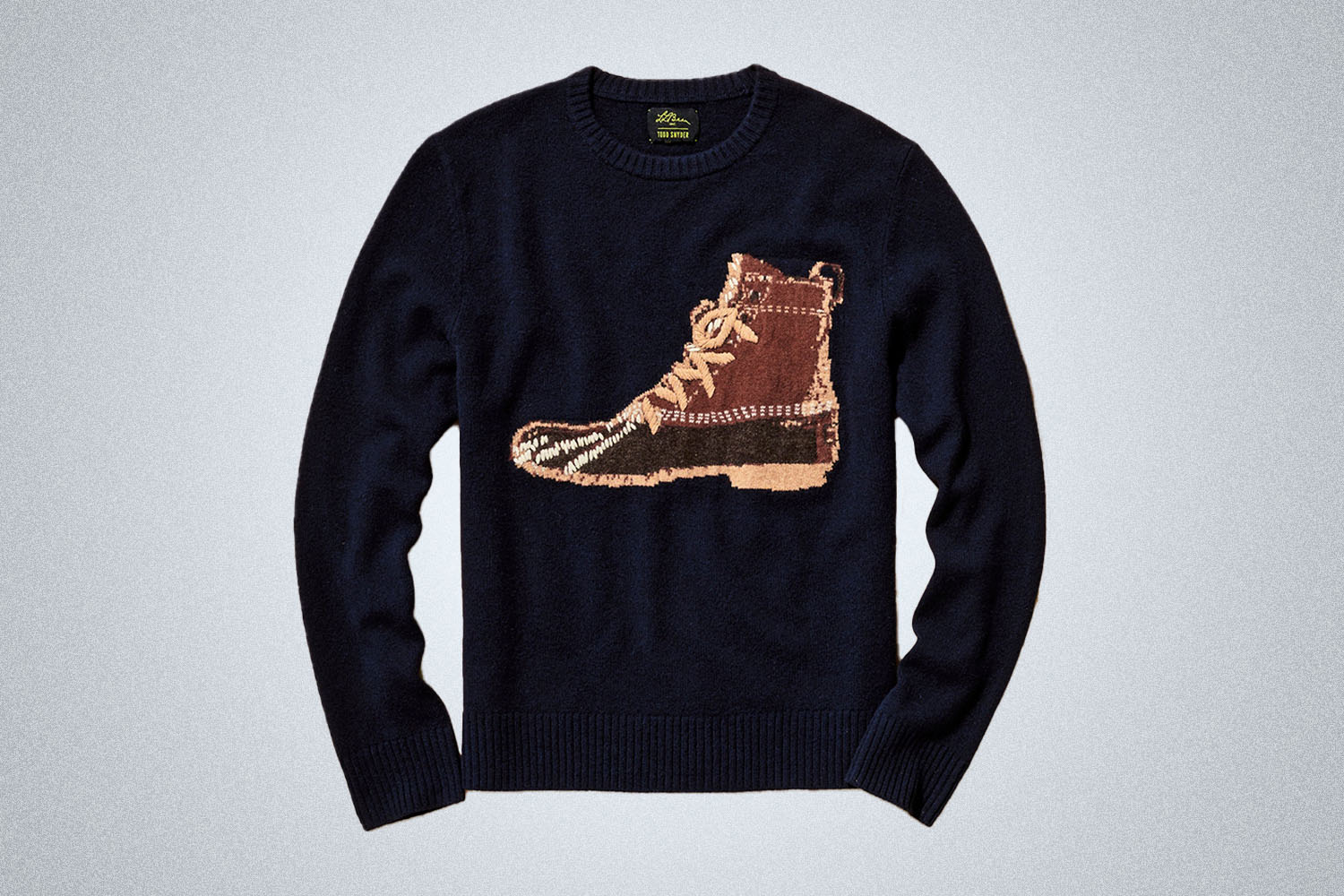 a knit blue sweater with a bean boot embroidered on the front 