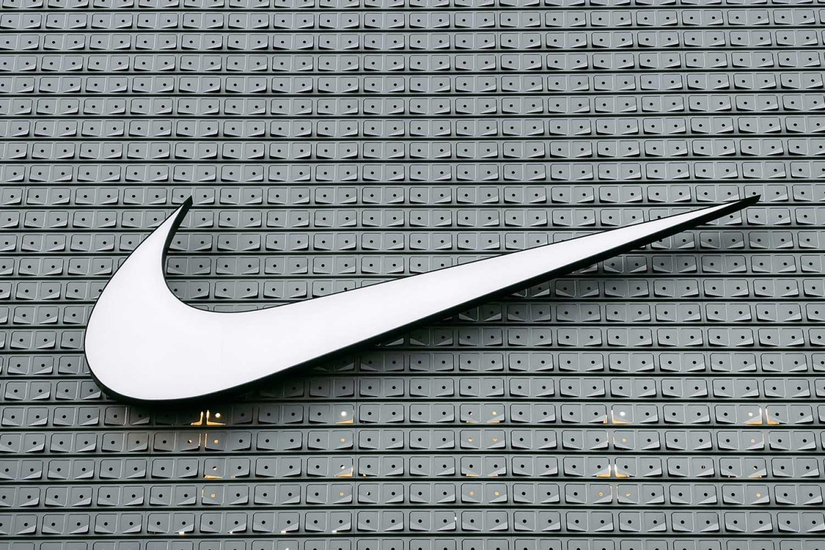 Nike's white swoosh logo on a grey building