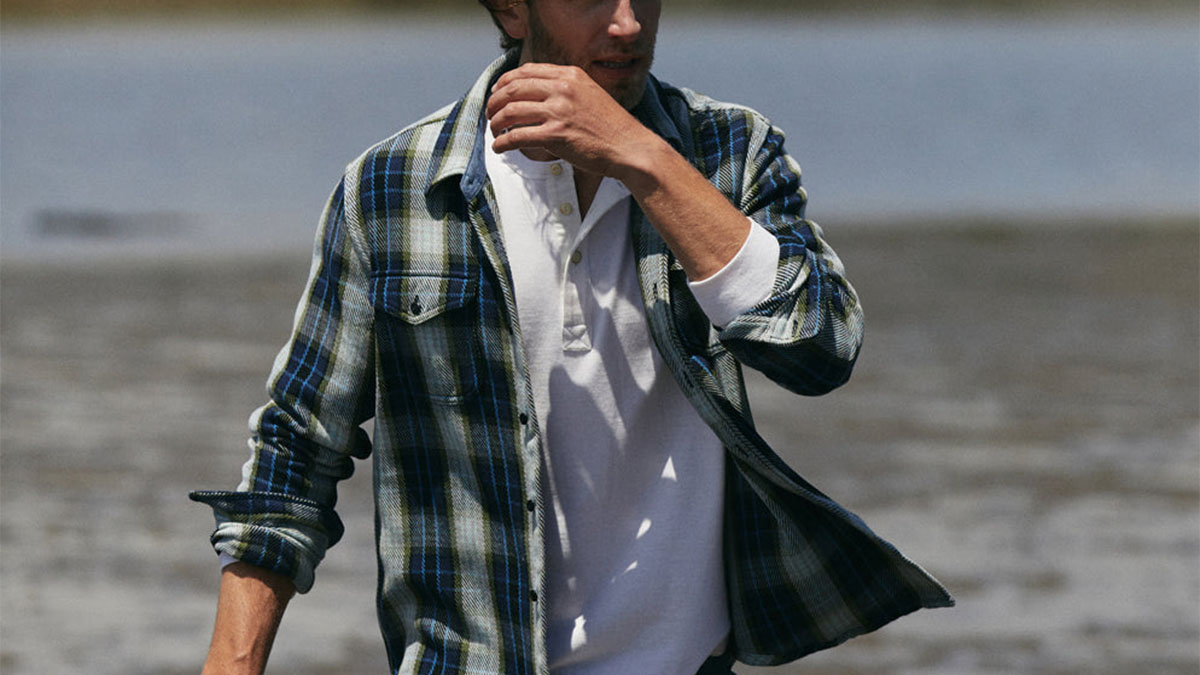 a model walking in an Outerknown blanket shirt