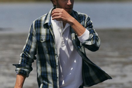 a model walking in an Outerknown blanket shirt