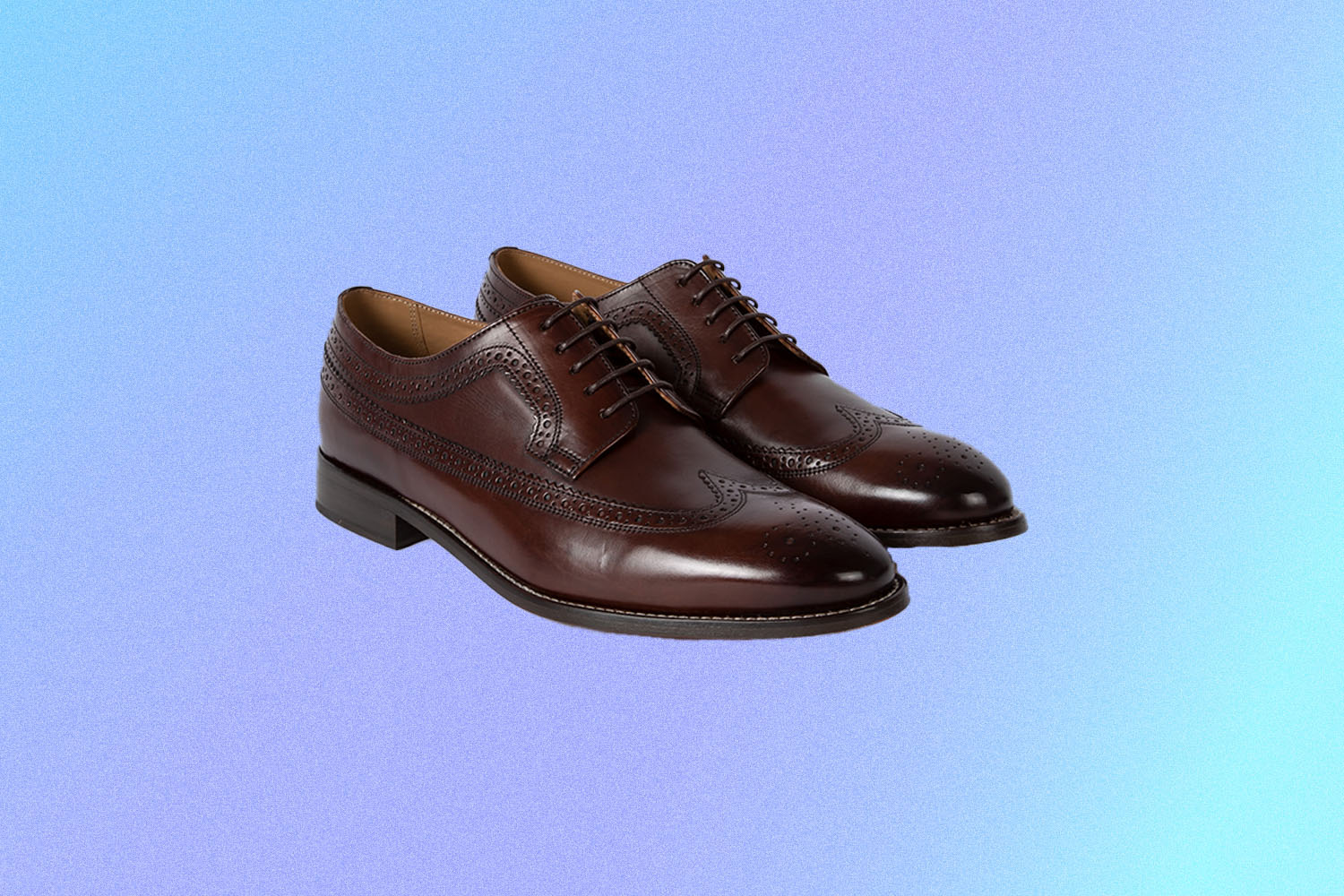 a pair of brogue dress shoes in brown leather on a multi-colored blue-purple background