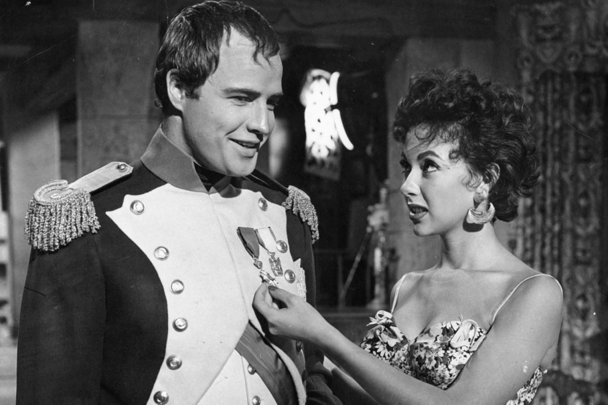 Marlon Brando and Rita Moreno visit on the set of the film 'Desiree', 1954. The couple dated for years; the actress recently claimed Brando "was a bad guy when it came to women."