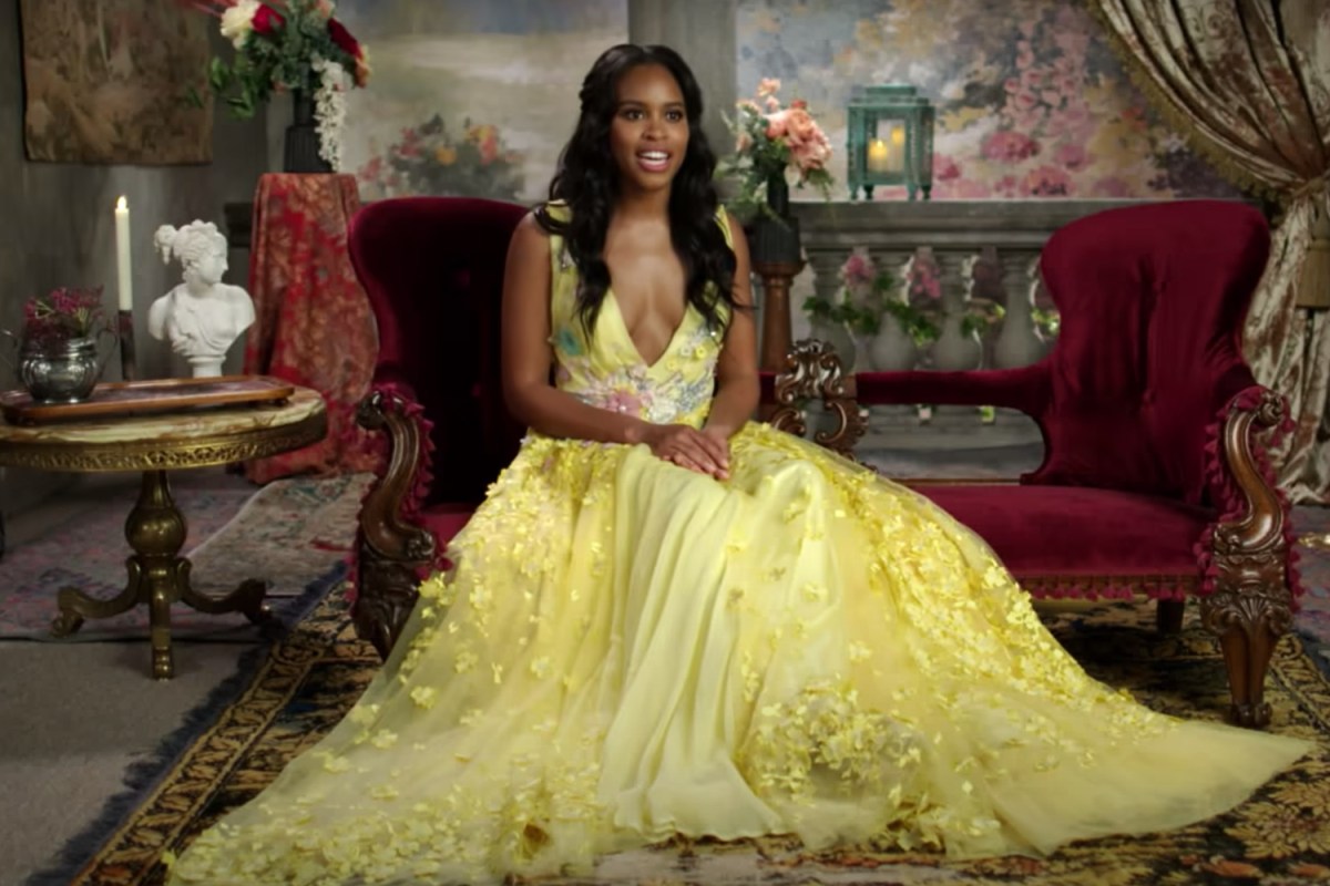 Star Nicole Remy poses in a yellow dress in the trailer for Peacock's new reality dating series "The Courtship"