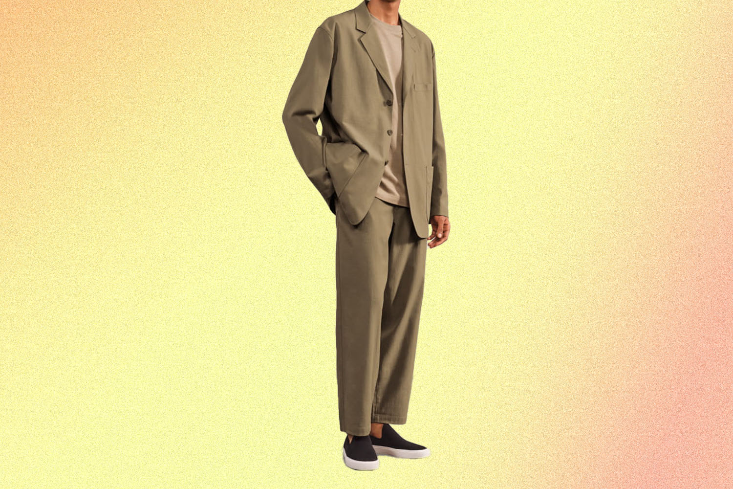 A model in a beige suit on a yellow background