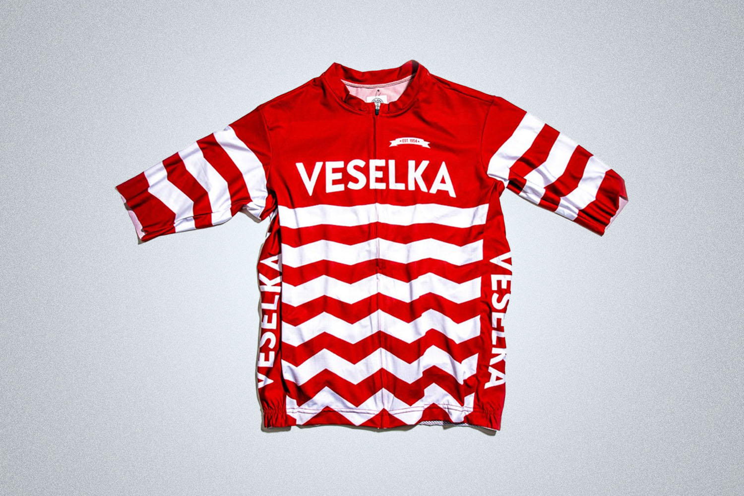 a red striped cycling jersey on a grey background