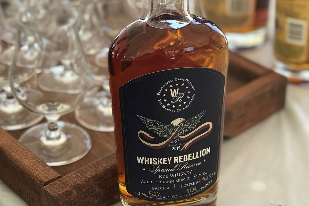a bottle of Whiskey Rebellion and some glasses, part of a stop on the Whiskey Rebellion Trail