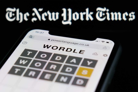 Wordle game displayed on a phone screen and The New York Times logo displayed in the background are seen in this illustration photo taken in Krakow, Poland on February 6, 2022