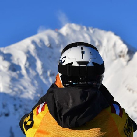 A competitor looks to the top of the mountain during the Freeride World Tour competition