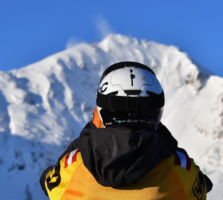 A competitor looks to the top of the mountain during the Freeride World Tour competition