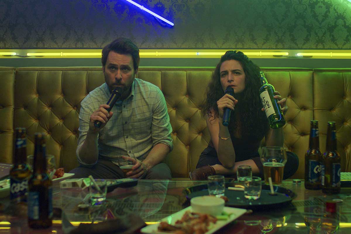 I Want You Back stars Charlie Day and Jenny Slate doing karaoke in a scene from their new romantic comedy