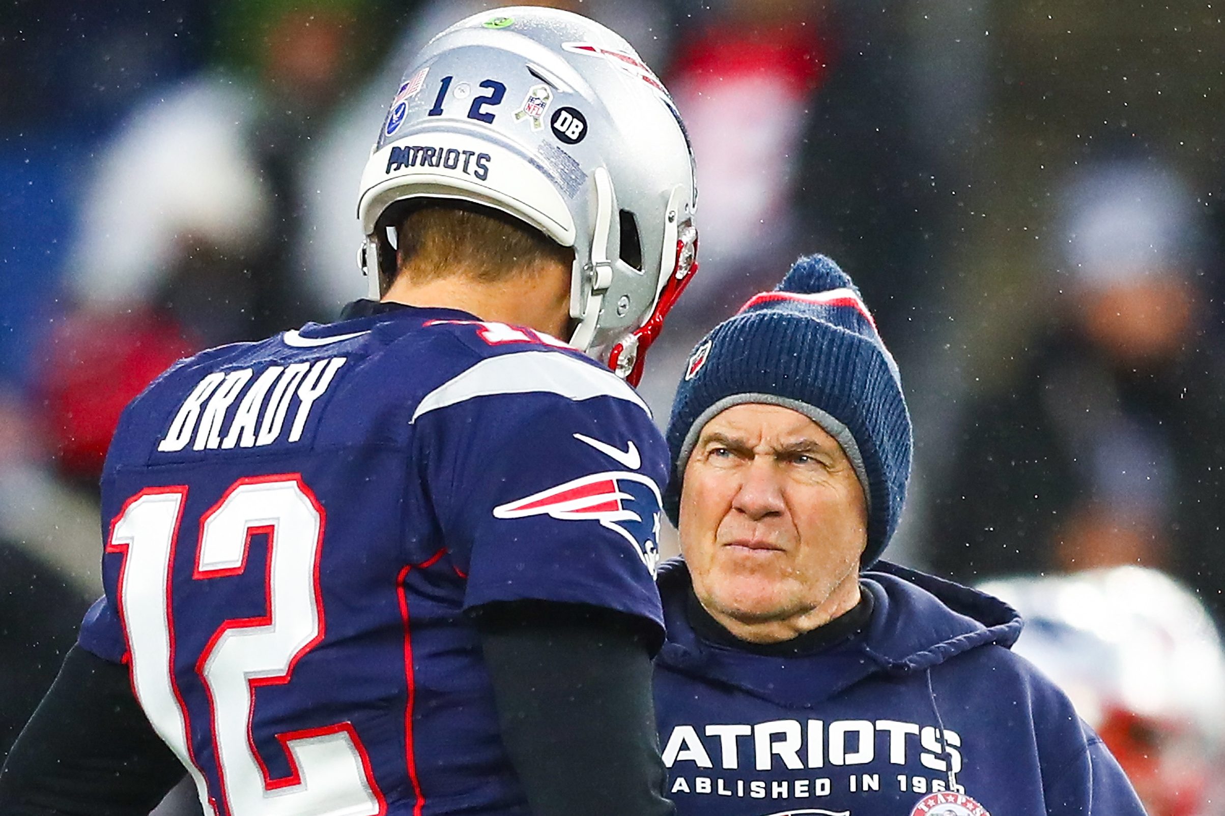 Tom Brady talks to Bill Belichick of the New England Patriots before a game with the Cowboys. In a statement about Brady's retirement, Belichick offered some subtle shade.