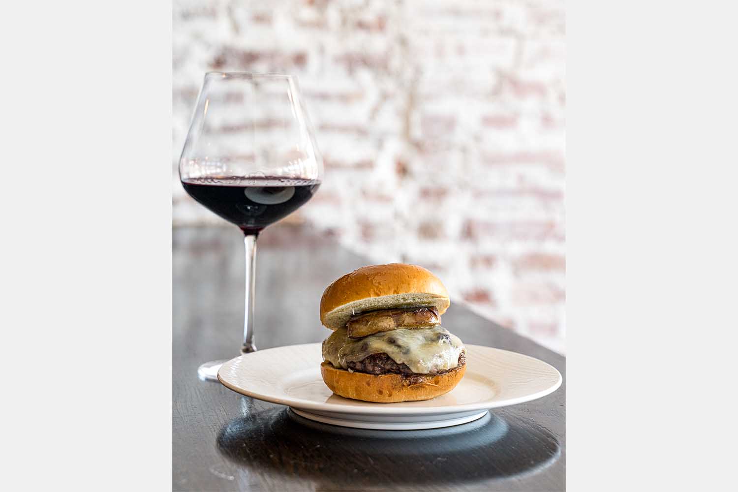 A burger and glass of red wine from DC's Duck Duck Goose 