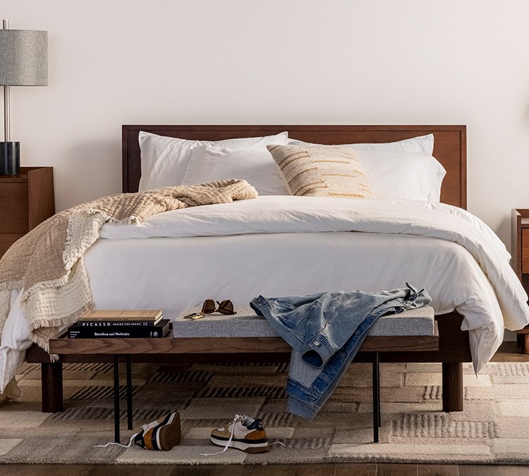 The Burrow Circa Bed with a headboard and a dark walnut finish. The DTC furniture company launched this Bedroom collection in February 2022.