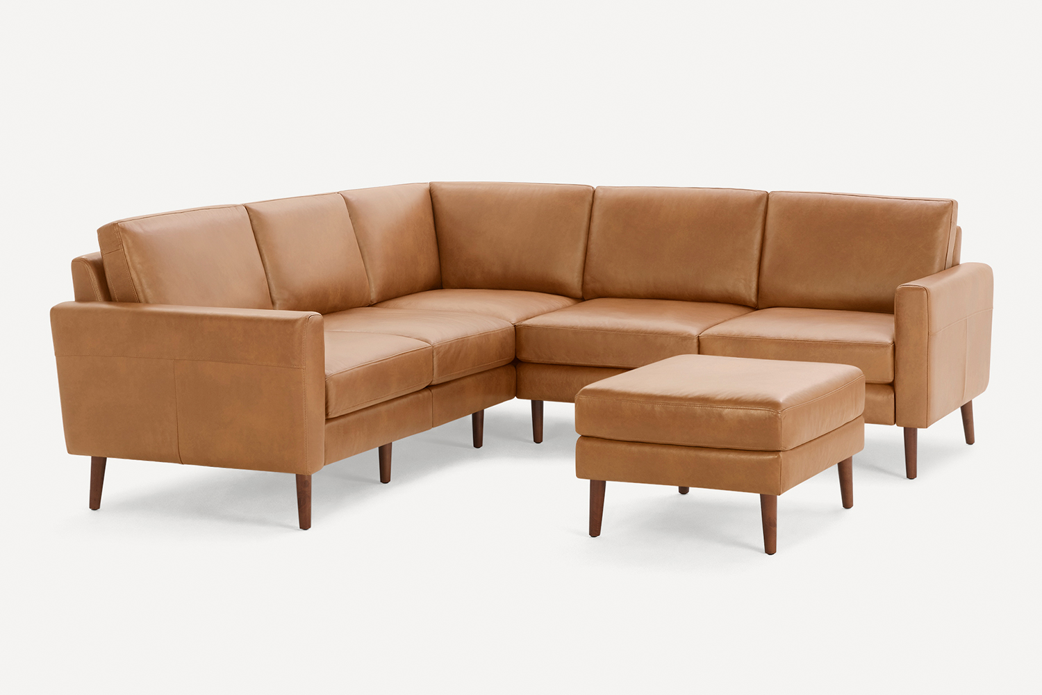 The five-seat Nomad Sofa in leather from Burrow, featuring an ottoman 