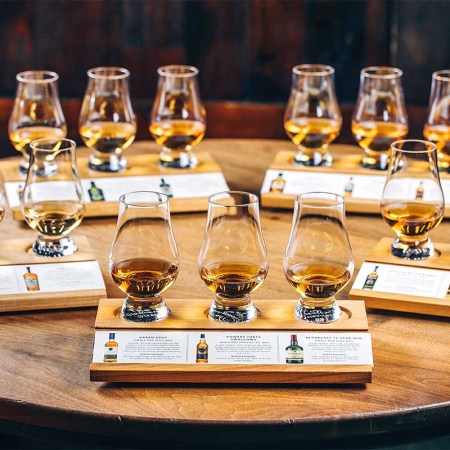 Tasting glasses on a table filled with different Irish whiskey samples. The styles of Irish whiskey are explained in "Paddy Drinks," a new book by the team behind the NYC bar The Dead Rabbit