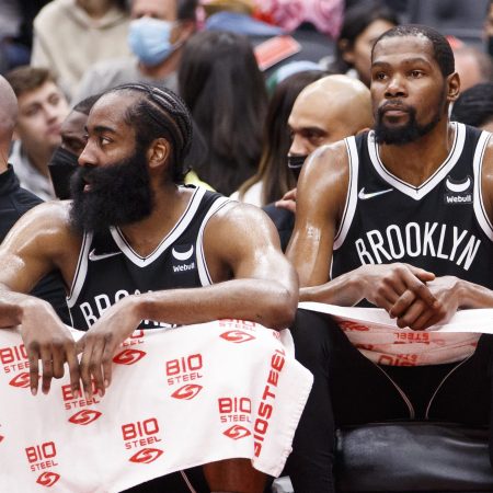 James Harden and Kevin Durant sit on the bench against the Toronto Raptors