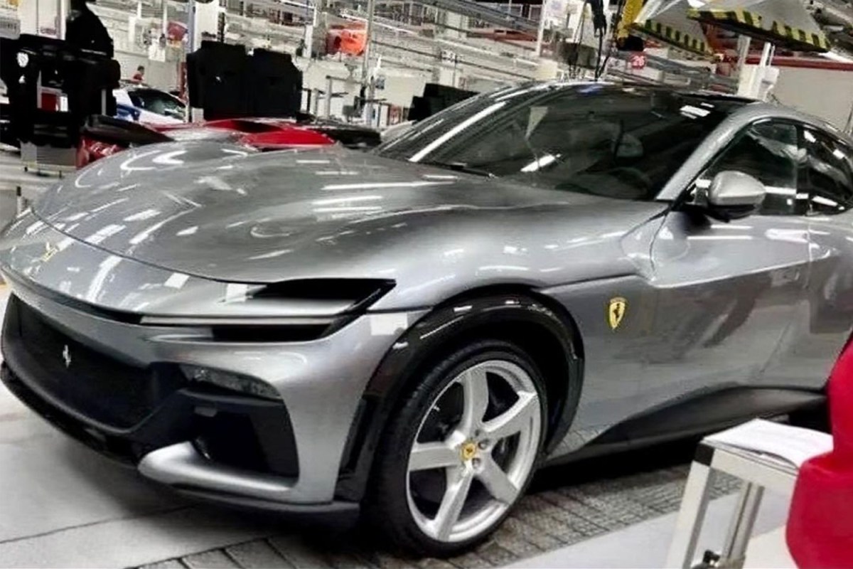 A leaked photo reportedly showing the front end of the Ferrari Purosangue SUV, a luxury sport utility vehicle in silver from the Italian sports car brand