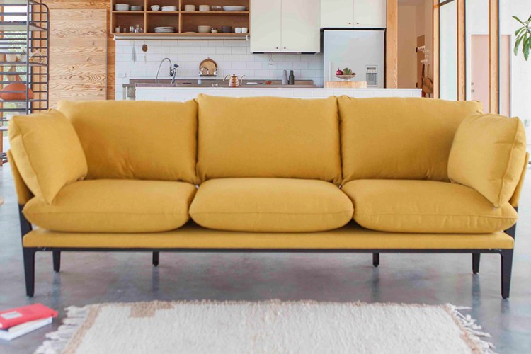 The Sofar from Floyd, a three-seat couch in saffron, which is on sale for President's Day 2022