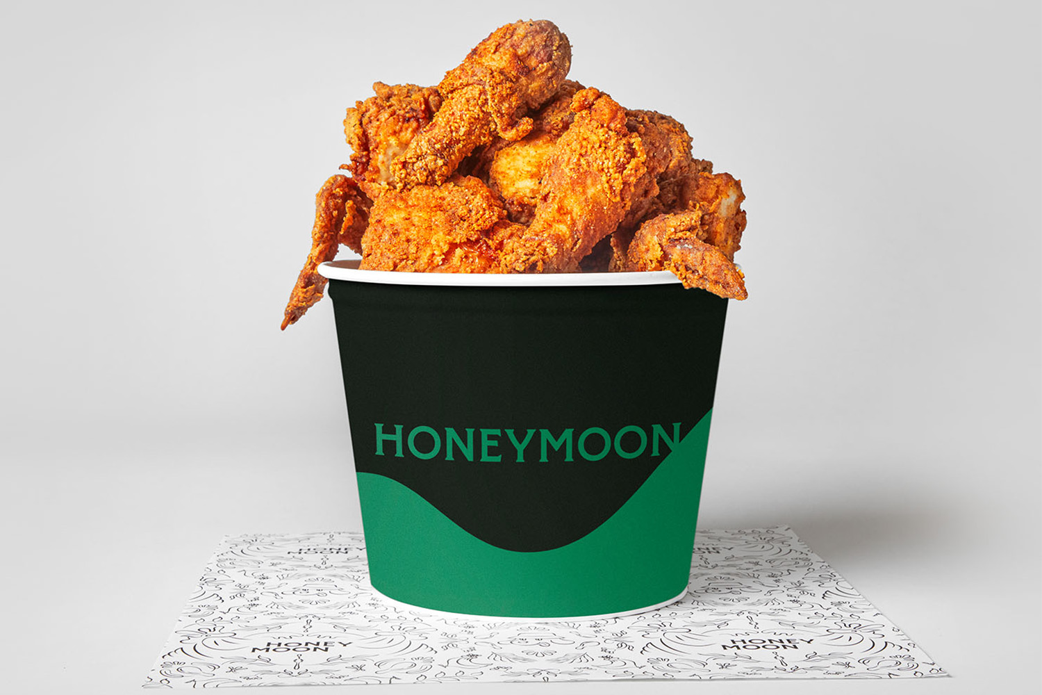 green and black bucket of fried chicken