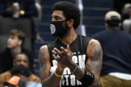 Kyrie Irving of the Brooklyn Nets cheers on his team against the Washington Wizards. NYC Mayor Eric Adams said he won't change rule barring Irving from playing in NYC even though it's "unfair."