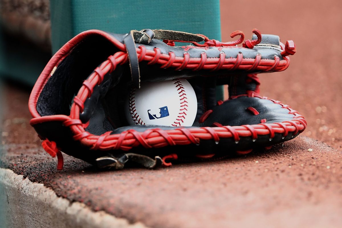 A detailed view of a ball inside a glove is seen in the Texas Rangers dugout. MLB Players and owners are currently stuck on hammering out a new labor deal.