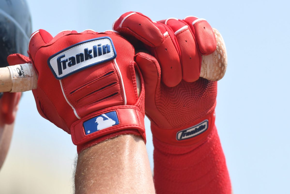 A detailed view of the Franklin batting gloves worn by Hunter Renfroe. MLB is arguing that minor league players should no be paid a salary during spring training.