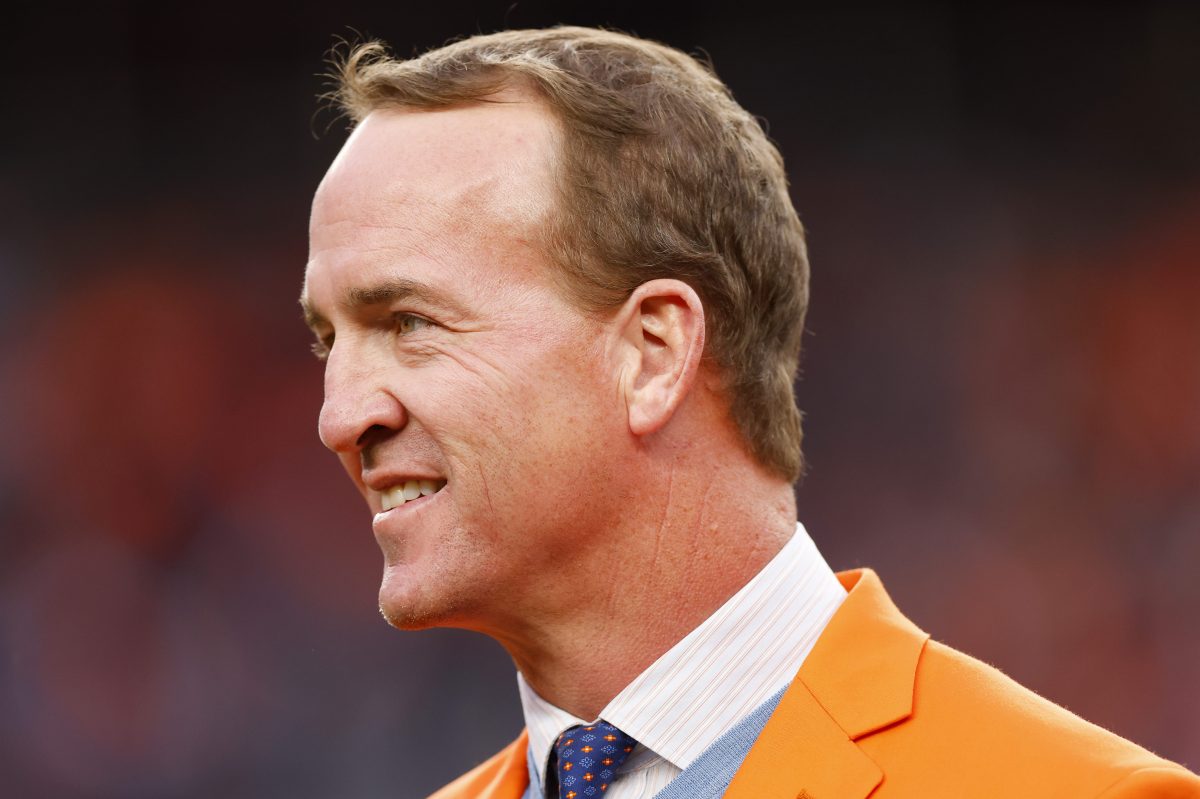 Peyton Manning looks on during a Ring of Honor induction ceremony at Empower Field At Mile High. ESPN recently announced that the format of his "Manning Cast" with Eli will be expanded to other sports, including golf and UFC.
