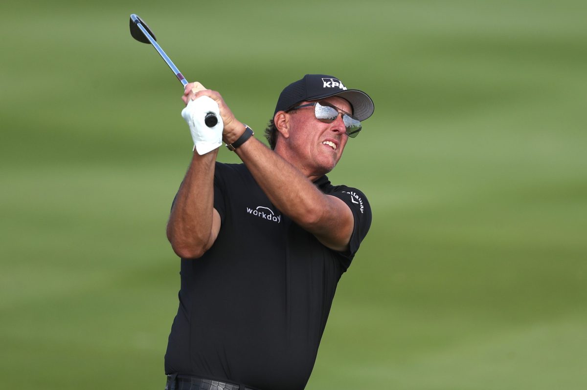 Phil Mickelson hits an approach shot at the PIF Saudi International