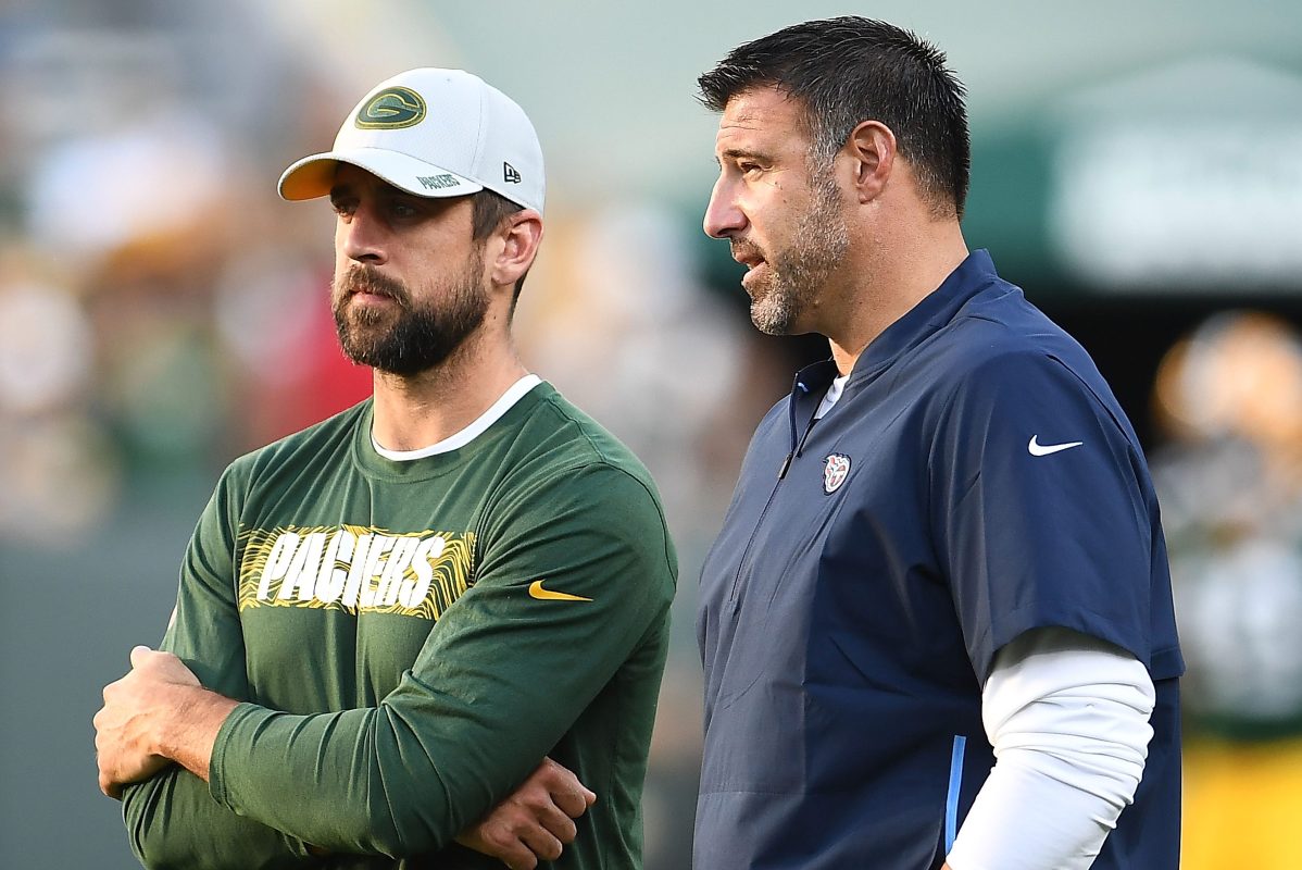 Aaron Rodgers speaks with head coach Mike Vrabel of the Tennessee Titans before a preseason game