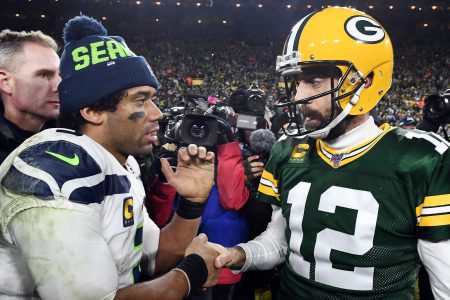 Russell Wilson greets fellow quarterback Aaron Rodgers at Lambeau Field in 2020